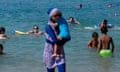 A woman wearing a burkini walks in the water on a beach in Marseille<br>A woman wearing a burkini walks in the water August 27, 2016 on a beach in Marseille, France, the day after the country's highest administrative court suspended a ban on full-body burkini swimsuits that has outraged Muslims and opened divisions within the government, pending a definitive ruling. REUTERS/Stringer