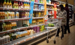 A customer shops for chilled fruit juice at a Sainsbury's supermarket in Walthamstow, east London