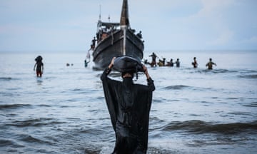 TOPSHOT-INDONESIA-MYANMAR-ROHINGYA-REFUGEE-AFP PICTURES OF THE YEAR 2023<br>TOPSHOT - -- AFP PICTURES OF THE YEAR 2023 -- A Newly arrived Rohingya refugee walks to the beach after the local community decided to temporarily allow them to land for water and food in Ulee Madon, Aceh province, Indonesia, on November 16, 2023.. About 250 Rohingya refugees reached western Indonesia on a overcrowded wooden boat on November 16, 2023, bringing the total number of refugees reported by local officials to have arrived this week to nearly 600. (Photo by amanda jufrian / AFP) / AFP PICTURES OF THE YEAR 2023 (Photo by AMANDA JUFRIAN/AFP via Getty Images)