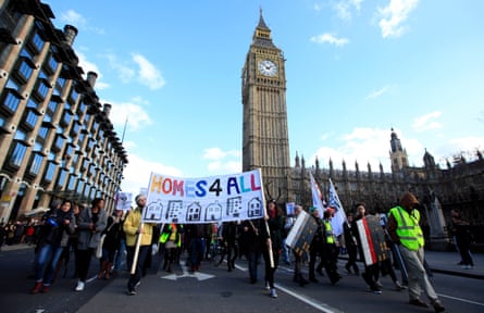 Protesters carrying a sign reading ‘Homes for All’ with Big Ben visible in the background