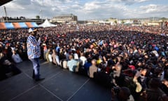 Raila Odinga speaks to supporters on a stage