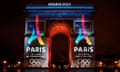 The Arc de Triomphe lit up with Paris 2024 logos.