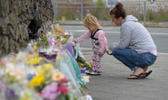 Child laying flowers for victims of Plymouth shooting