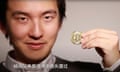 Sam Lee holds up a bitcoin