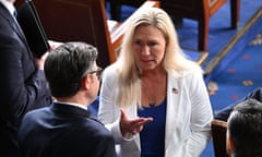 woman wearing white talks to man wearing glasses