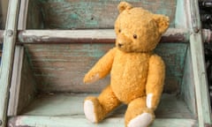 A teddy bear sitting on stairs.