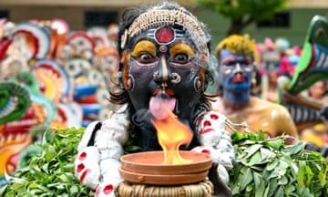 An artist dressed as Hindu deity Mahakali, performs during a procession to mark Bonalu festival at Akkanna Madanna temple in Hyderabad