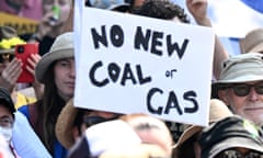Protesters holding a 'no new coal or gas' placard