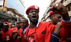 TOPSHOT-UGANDA-INTERNET-TAXATION<br>BOBI WINE: THE PEOPLE’S PRESIDENT - press film still - Musician turned politician Robert Kyagulanyi Ssentamu aka Bobi Wine (C) is joined by other activists in Kampala on July 11, 2018 in Kampala during a demonstration to protest a controversial tax on the use of social media. - Police fired live bullets and teargas to disperse a rowdy crowd during the protests. (Photo credit should read ISAAC KASAMANI/AFP via Getty Images)