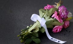 Flowers with a ribbon reading ‘RIP’ left at an entrance to Westfield Bondi Junction 