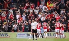 Wrexham celebrate and Stockport’s Ryan Rydel is dejected during their recent National League match