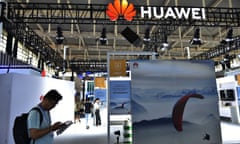 Man on mobile phone under Huawei logo