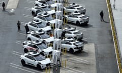 Waymo vehicles sit parked in a staging area in San Francisco, California.