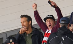 Wrexham owners Ryan Reynolds and Rob McElhenney celebrate the opening goal against Torquay.