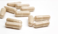Natural vitamin supplements on a white flat surface
