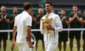 Novak Djokovic walks past Roger Federer