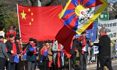 Pro-China supporters and anti-China protesters wave flags and banners
