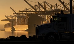A truck arrives to pick up a shipping container near vessels at the Port of Los Angeles