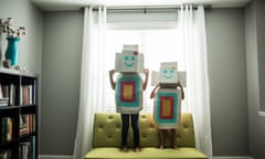 Young girls wearing homemade robot costumes at home.