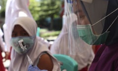 Health workers prepare to give an HPV injection to a pupil during a free vaccination service in Indonesia. 