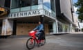 A person cycles past the boarded-up Oxford Street branch of Debenhams in central London