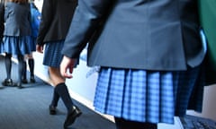 Female students walking along a corridor. 