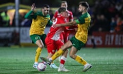 Barnsley’s Aiden Marsh feels the squeeze from two Horsham players in their FA Cup replay.