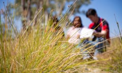 Health workers speak to a woman outside her Northern Territory community