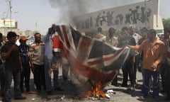 Iraqis burn a British flag in Baghdad to protest at the 2003 killing of Baha Mousa