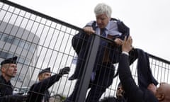 Air France executive Pierre Plissonnier is helped to escape angry staff by police.