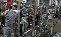 Workers on a production line at a factory in Xinzhuang industry zone in Shanghai, China.