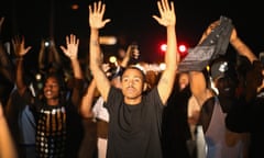 Outrage In Missouri Town After Police Shooting Of 18-Yr-Old Man<br>FERGUSON, MO - AUGUST 12:  Demonstrators protest the killing of teenager Michael Brown on August 12, 2014 in Ferguson, Missouri. Brown was shot and killed by a police officer on Saturday in the St. Louis suburb of Ferguson. Ferguson has experienced two days of violent protests since the killing but, tonight's protest was peaceful.  (Photo by Scott Olson/Getty Images)