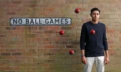 20 year old Cricketer Haseeb Hameed standing in front of a brick wall with four cricket balls mid-bounce around him and a sign on the wall saying 'no ball games'