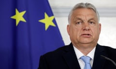 Close-up headshot of Viktor Orbán, the Hungarian Prime Minister, with a European flag behind him