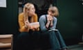 Two colleagues sitting on a step outside office having lunch