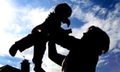 A MOTHER AND CHILD PLAY AT HOME IN LONDON