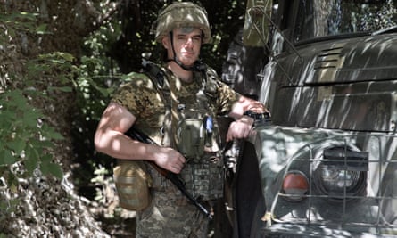 Odesa poses next to an armoured vehicle