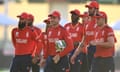 Jos Buttler of England (centre) leads his team off the field after their victory over Namibia in Antigua.