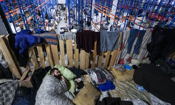 A man sleeps in a former customs centre in the village of Bruzgi, at the Belarus-Poland border, that has been turned into a dormitory for asylum seekers.