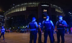 Chicago police officers stand outside Guaranteed Rate Field on Friday night. Police are investigating a shooting at the White Sox game at the stadium.