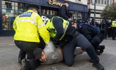 Gardai restrain a protester during an anti-lockdown protest in Dublin city centre