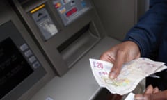Someone withdraws cash from an ATM