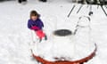 Imogen Adams plays on a snow-covered playground in Nimmitabel, NSW, Thursday, June 10, 2021. (AAP Image/Lukas Coch) NO ARCHIVING