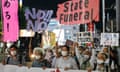 Protesters hold banners in Tokyo last month against the coming state funeral for Shinzo Abe