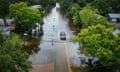 TOPSHOT-US-CUBA-MEXICO-WEATHER<br>TOPSHOT - An aerial view shows a vehicle driving along a flooded street in New Port Richey, Florida, on August 30, 2023, after Hurricane Idalia made landfall. Idalia slammed into northwest Florida as an "extremely dangerous" Category 3 storm early Wednesday, buffeting coastal communities with cascades of water as officials warned of "catastrophic" flooding in parts of the southern US state. (Photo by Miguel J. Rodriguez Carrillo / AFP) (Photo by MIGUEL J. RODRIGUEZ CARRILLO/AFP via Getty Images)