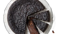 Caribbean black cake on a plate, with a cake server and crumbs next to it.