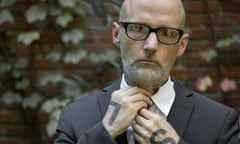 Moby in a suit and tie, the letters 'L' and 'S' on the backs of his hands