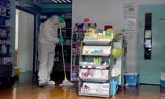 A worker in a protective suit inside of County Oak Medical Centre in Brighton