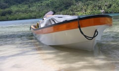 A fiberglass dinghy berthed on the shores of Peli Island in Manus Province, Papua New Guinea. These boats are also called banana boats by the locals.<br>2ETAM6E A fiberglass dinghy berthed on the shores of Peli Island in Manus Province, Papua New Guinea. These boats are also called banana boats by the locals.