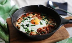 Poached egg in tomato sauce, paprika and spices, arabic shakshouka, single serving in iron cast pan, vegetarian dish